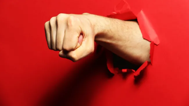 fist punch through red paper